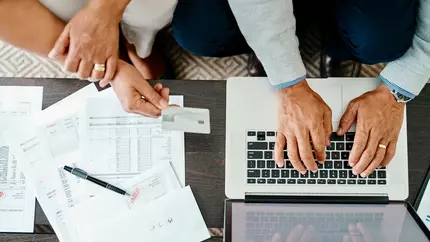 man and woman conducting business on a laptop
