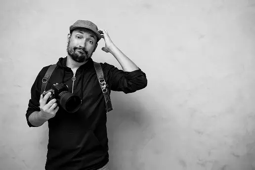 Photographer wearing a hat and holding a camera